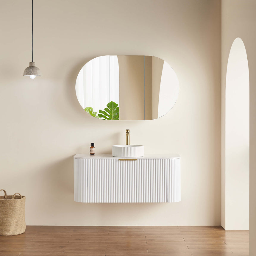 Lukka Allison shaving cabinet installed in modern bathroom with rounded mirror and white vanity by Tilemall