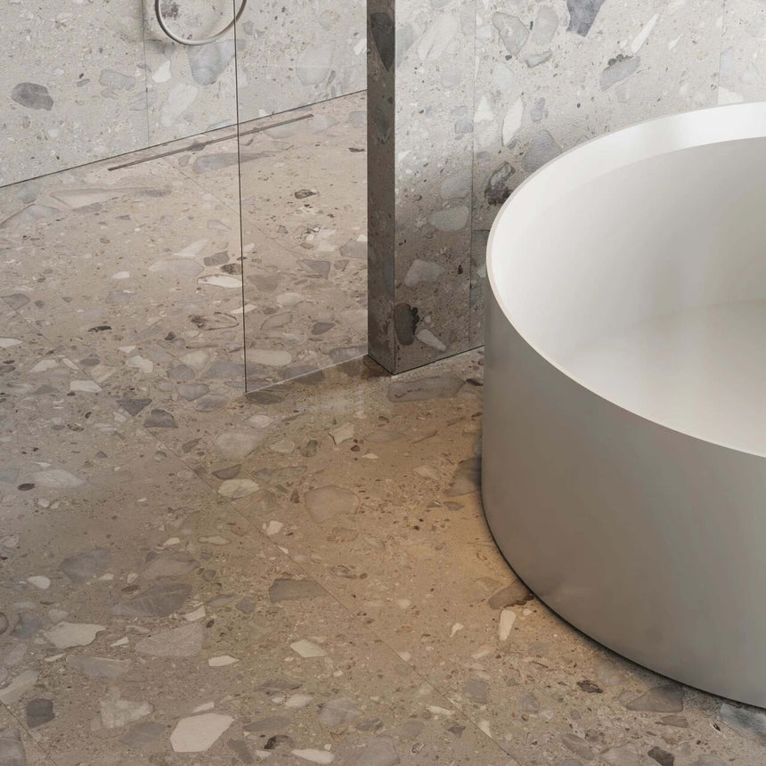 Close-up of Sassi 600x600mm matt taupe terrazzo porcelain surface with grey marble and white stone chip detail by Tilemall
