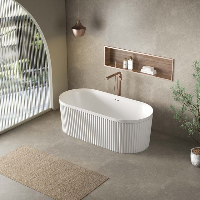 Florence 1700x800mm freestanding fluted bathtub by Tilemall installed in modern bathroom interior with wall-hung tap and wooden shelf