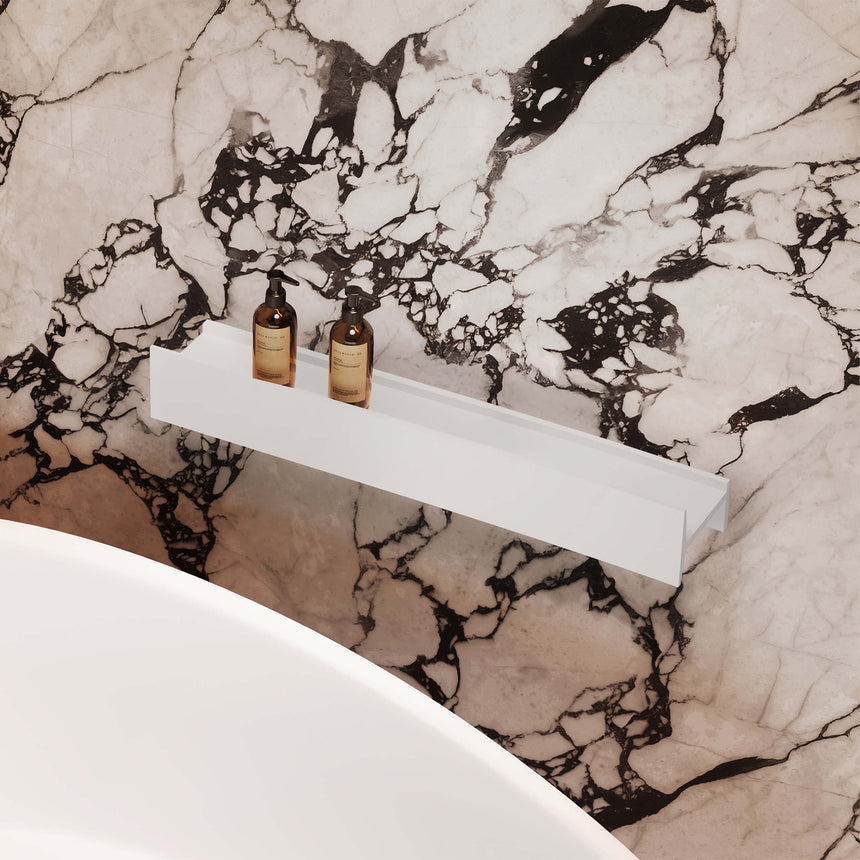 BelBagno H Collection 800x140mm close-up of white shelf holding glass bottles against black and white marble wall by Tilemall