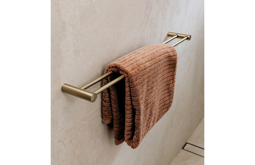Phoenix Vivid Slimline Double Towel Rail 800mm Brushed Gold, shown in a finished interior