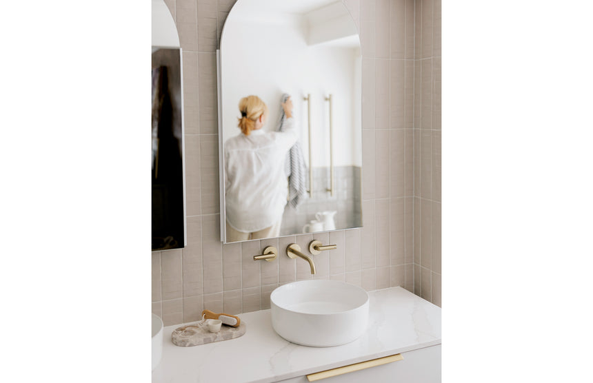 Phoenix Vivid Slimline Plus Wall Basin / Bath Outlet 180mm Brushed Gold, shown in a finished interior