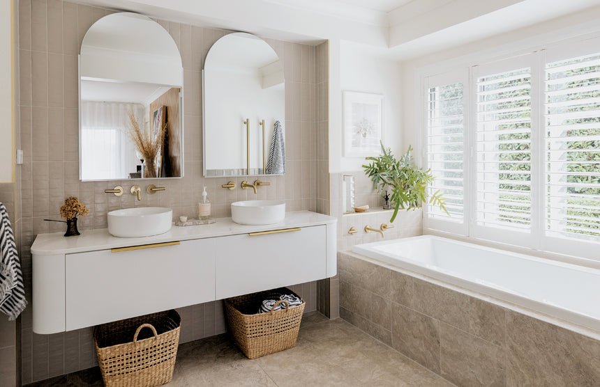 Phoenix Heated Triple Towel Rail Round 800mm Brushed Gold, shown in a finished interior
