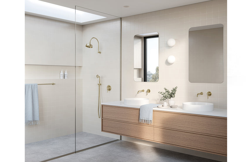 Phoenix Cromford Wall Basin / Bath Outlet Brushed Gold, shown in a finished interior