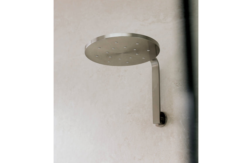 Phoenix Vivid Slimline High-Rise Shower Arm Round Plate Brushed Nickel, shown in a finished interior