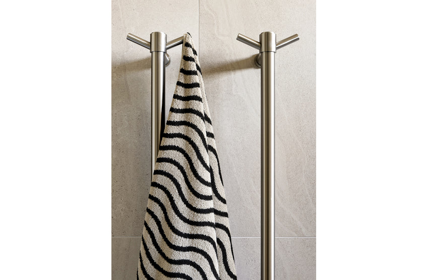 Phoenix Heated Towel Rail Round 800mm Brushed Nickel, shown in a finished interior