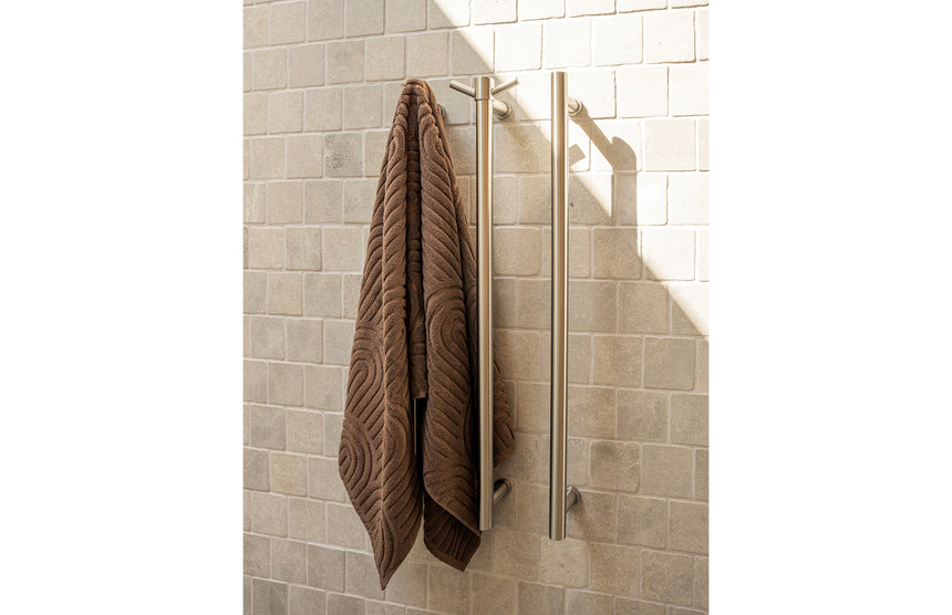Phoenix Heated Triple Towel Rail Round 800mm Brushed Nickel, shown in a finished interior
