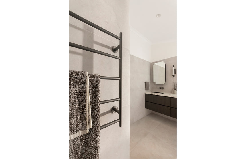 Phoenix Radii Heated Towel Ladder 750mm x 740mm Brushed Carbon, shown in a finished interior