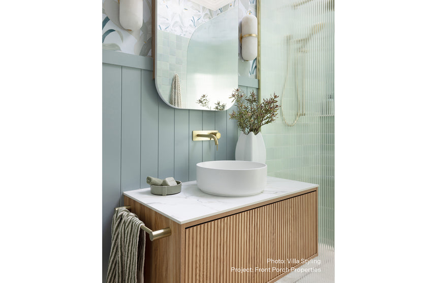 Phoenix Vivid Slimline SwitchMix Wall Basin / Bath Mixer Set 180mm Brushed Gold, shown in a finished interior