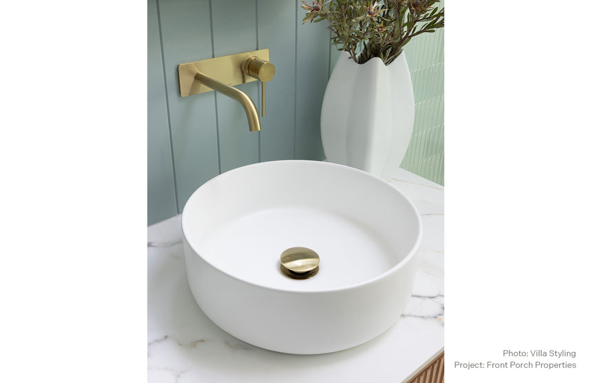 Phoenix 40mm Dome Pop Up Universal Waste Brushed Gold, shown in a finished interior