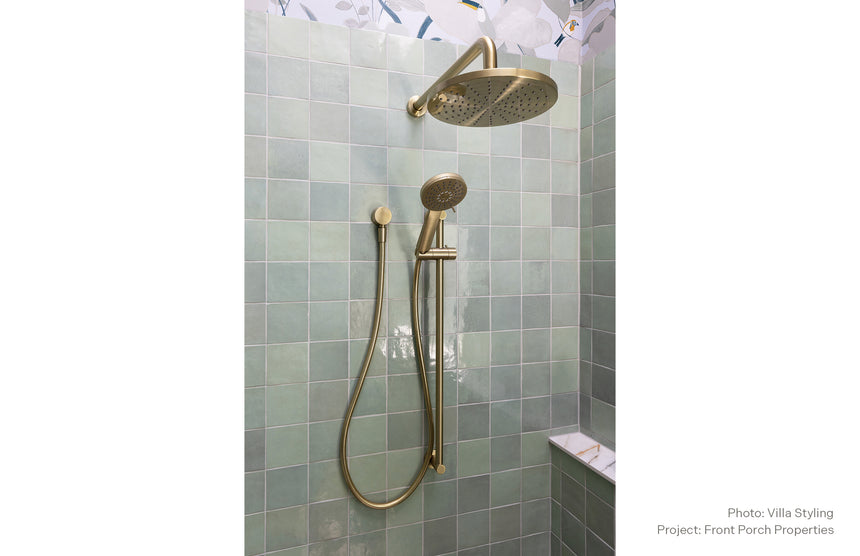 Phoenix Vivid Shower Rose 230mm Round Brushed Gold, shown in a finished interior