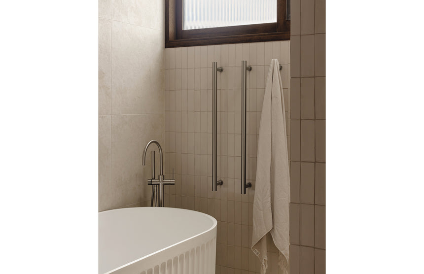 Phoenix Heated Triple Towel Rail Round 800mm Brushed Nickel, shown in a finished interior