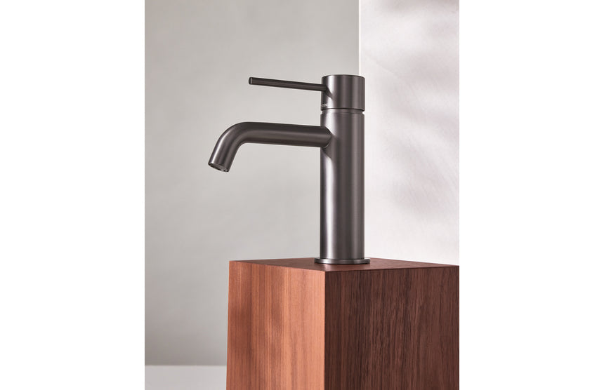 Phoenix Vivid Slimline Basin Mixer Curved Outlet Brushed Carbon, shown in a finished interior