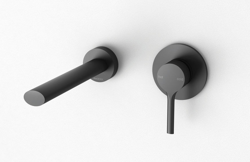 Phoenix Vivid Slimline Oval Wall Basin Outlet 180mm Matte Black, shown in a finished interior