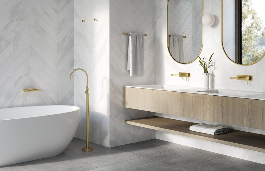 Phoenix Vivid Slimline Oval Floor Mounted Bath Mixer Brushed Gold, shown in a finished interior